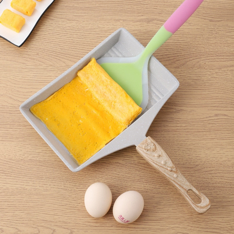 Non-Stick Wave Bottom Tamagoyaki Omelette Saucepan with wooden handle cooking a folded omelette