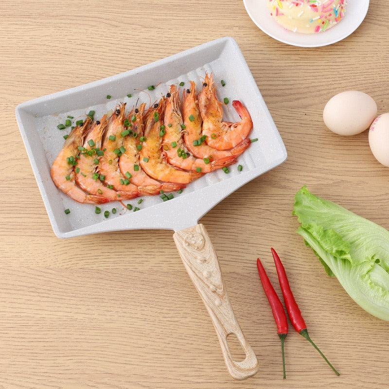 Non-Stick Wave Bottom Tamagoyaki Omelette Saucepan with cooked shrimp and garnished with chopped green onions