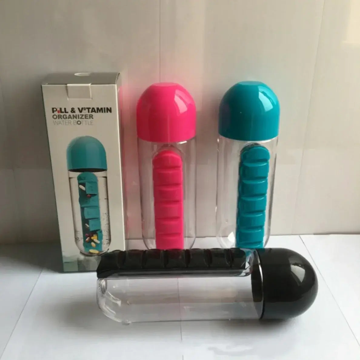 FreshWave Essentials pill organizer water bottle with colorful compartments and caps in pink, blue, and black