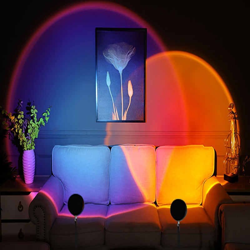 Aesthetic sunset projection lamp casting vibrant purple and orange lights over a living room sofa