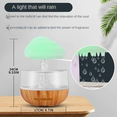 Desktop rain cloud humidifier with wood grain base and green cloud-shaped top releasing mist and water droplets