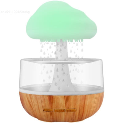 Desktop rain cloud humidifier with wood grain base and green cloud-shaped mist diffuser