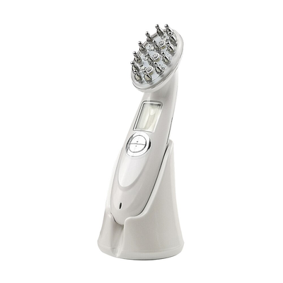 White handheld laser hair regrowth device with metal treatment nodes and digital display on charging stand