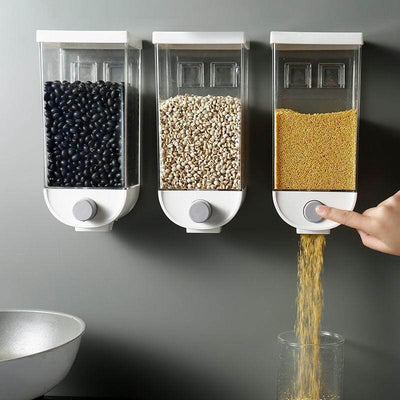 Wall mounted grain dispenser set with three containers holding black beans, white grains, and yellow grains being dispensed
