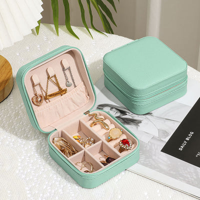 Mint green Jewelry Zipper Box Storage open showing organized rings, necklaces, and bracelets with closed box beside it