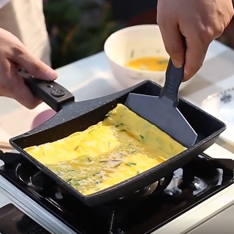 Non-Stick Wave Bottom Tamagoyaki Omelette Saucepan with person cooking a folded omelette using a spatula