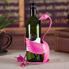 Pink flamingo wine holder creatively designed to hold a wine bottle on a table