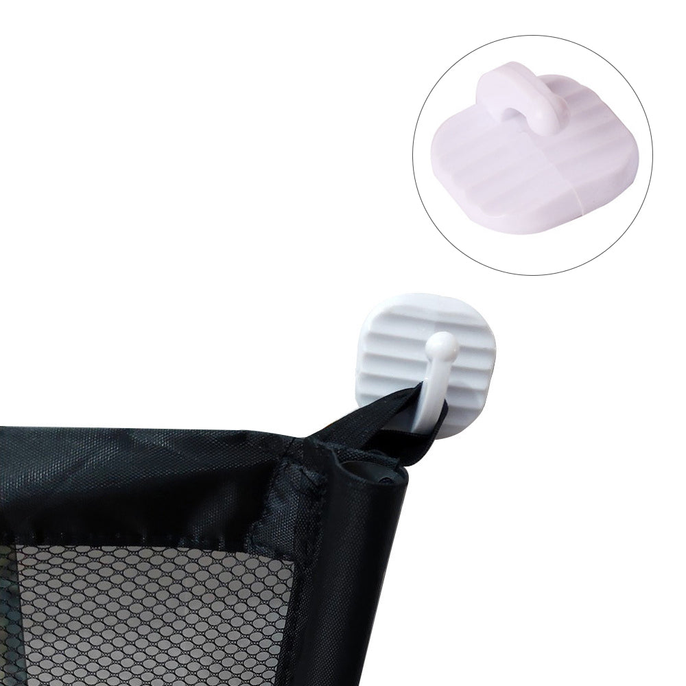 Close-up of portable pet safety gate attachment hook securing black mesh gate fabric