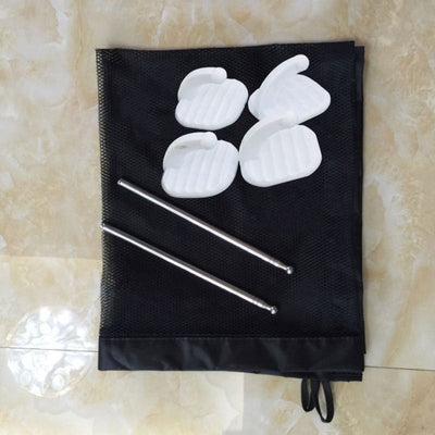 Unassembled portable pet safety gate components including black mesh fabric, white plastic clips, and metal rods