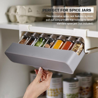 Self-adhesive spice rack with pull-out compartment holding seven spice jars for kitchen organization