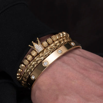 Gold stainless steel Roman bracelets with crown charm and diamond accents on wrist
