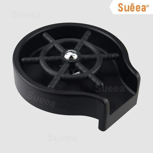 Black kitchen sink cup washer with circular design and central spinner for effective cleaning