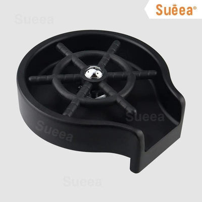 Black kitchen sink cup washer with circular design and central spinner for effective cleaning