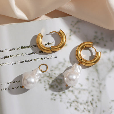 Elegant water drop earrings with gold hoop and white pearl drop design on white background