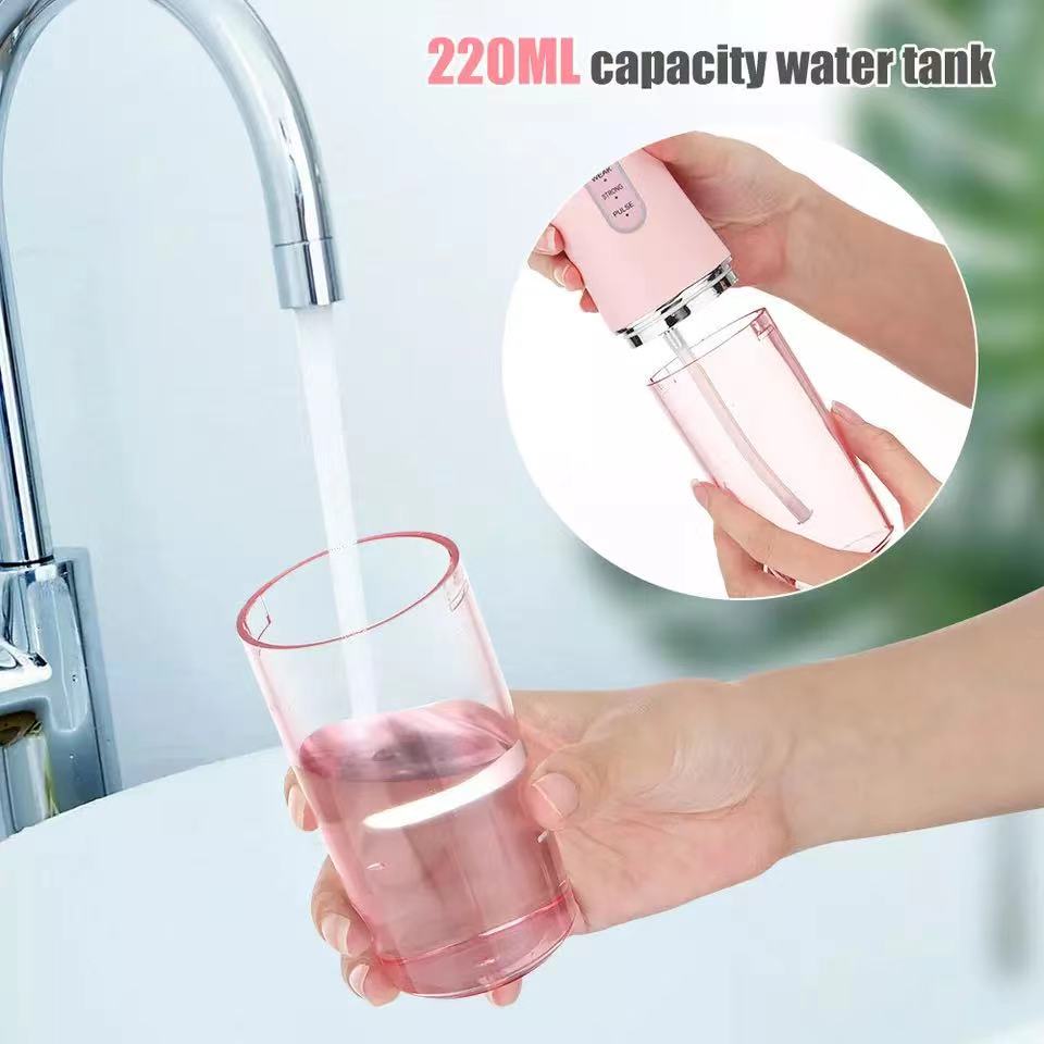 Water filling a 220ML capacity water tank of a waterproof dental irrigator in pink