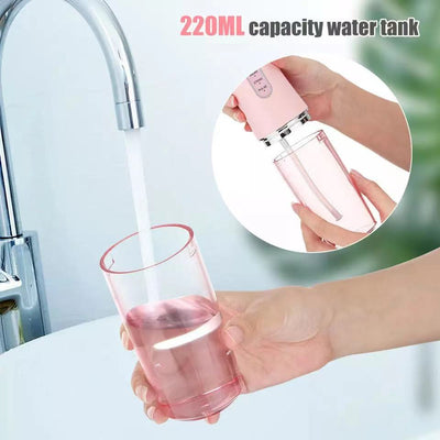 Water filling a 220ML capacity water tank of a waterproof dental irrigator in pink