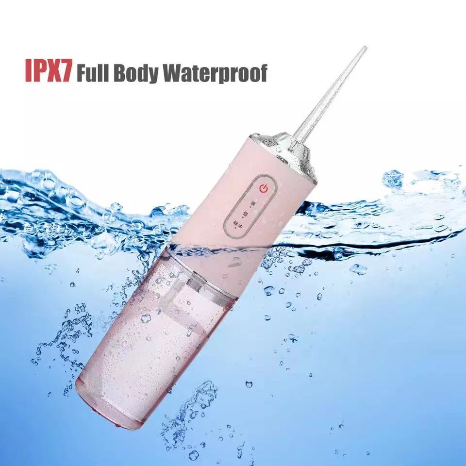 Pink waterproof dental irrigator with IPX7 full body waterproof rating submerged in water